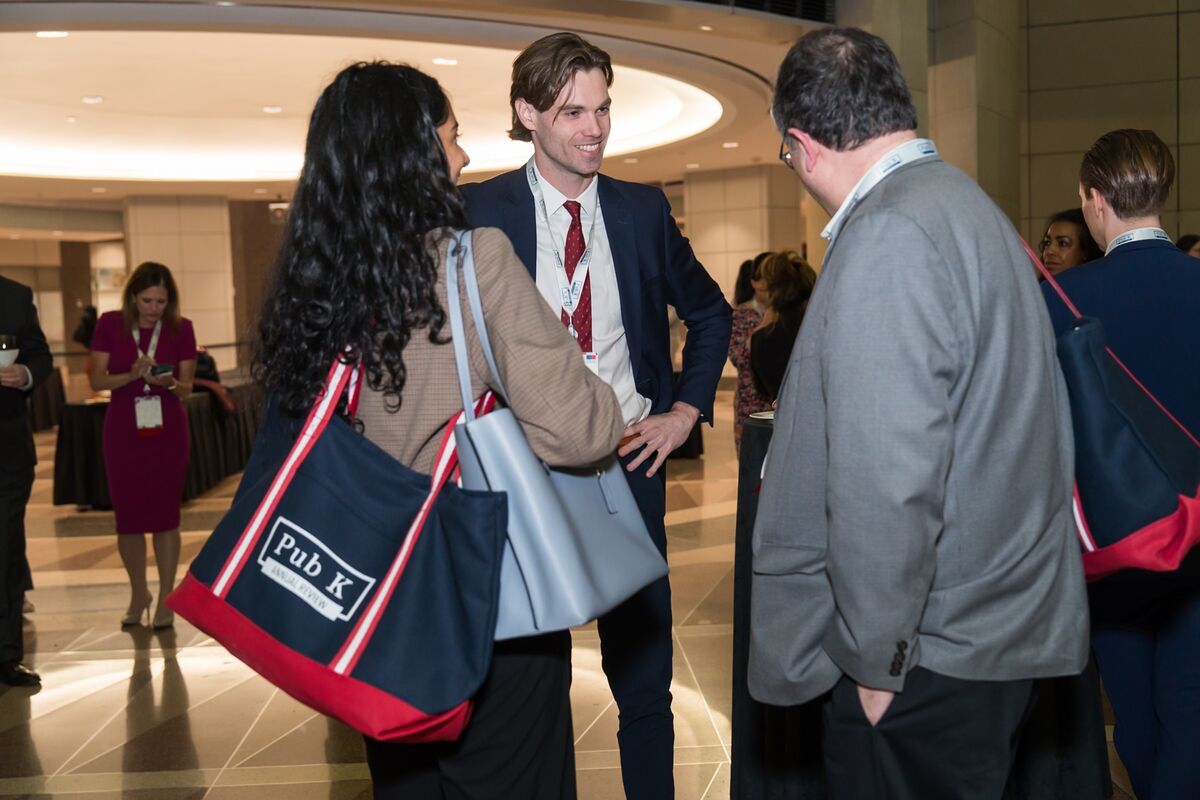 Attendees networking with Pub K Annual Review totes